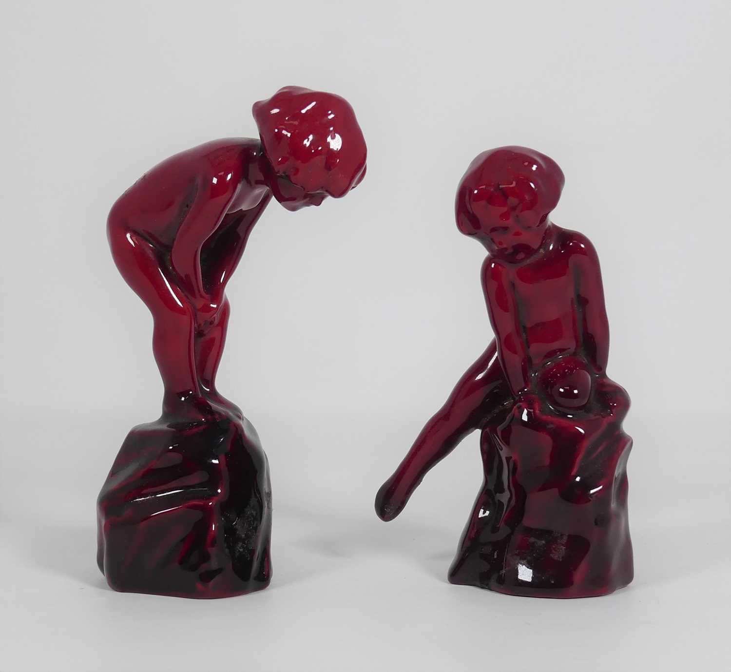 Lot 74 - Two Royal Doulton red flambé figures of...