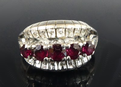 Lot 355 - A white metal ruby and diamond three-row...