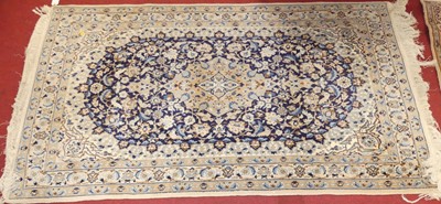 Lot 1181 - A Persian woollen cream and blue ground Nain...