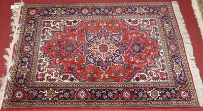 Lot 1179 - A Persian woollen red ground Keshan Shad Sar...