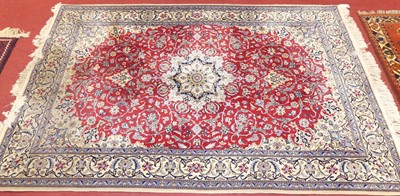 Lot 1171 - A Persian silk red, cream and blue ground...