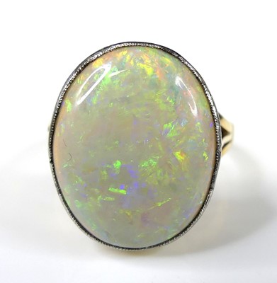 Lot 2265 - A 15ct gold opal dress ring, featuring an oval...