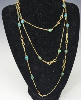 Lot 2273 - A yellow metal long turquoise set guard chain,...