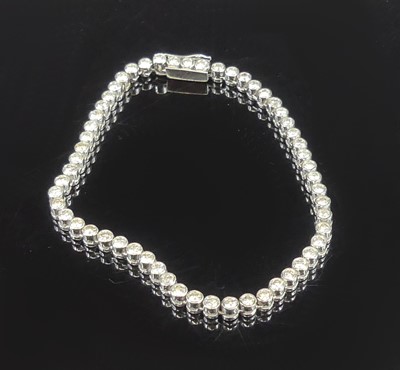 Lot 2225 - An 18ct white gold diamond tennis bracelet,...