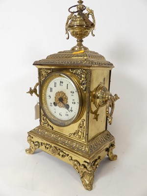 Lot 31 - An early 20th century brass cased mantel clock,...