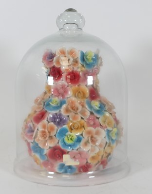 Lot 115 - A modern floral encrusted pottery vase, housed...