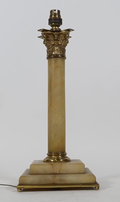 Lot 121 - A brass and alabaster table lamp in the form...