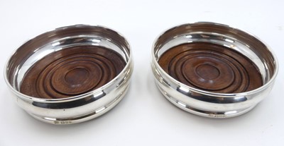 Lot 254 - A pair of modern silver bottle coasters, each...