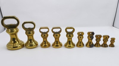 Lot 266 - A graduated set of ten brass bell weights, the...