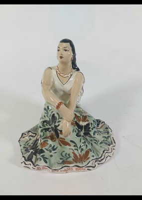 Lot 246 - A Soviet pottery figure of a lady modelled...