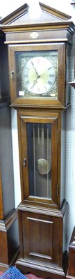 Lot 1136 - A reproduction oak longcase clock, having...