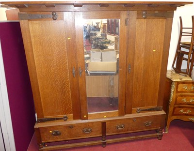 Lot 1184 - A Heal & Sons Arts & Crafts oak triple...