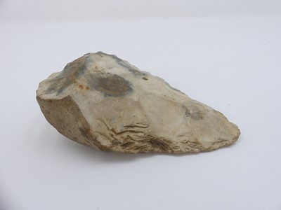 Lot 562 - A carved flint axe head, possibly Neolithic,...