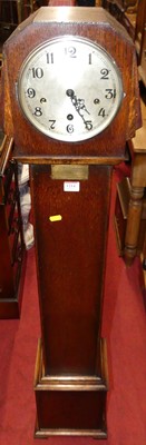 Lot 1214 - An Art Deco oak striking and chiming...