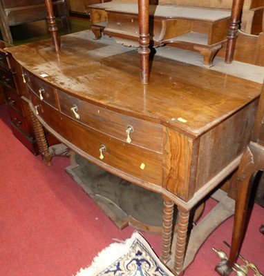 Lot 1224 - An Edwardian walnut bow front swing mirror...