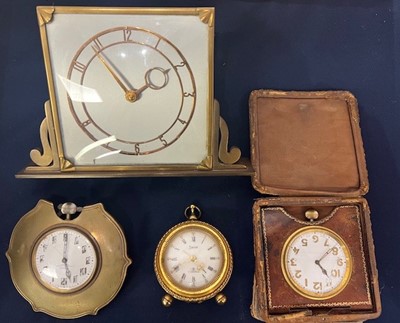 Lot 581 - An Art Deco brass framed bedside clock, the...