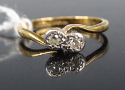 Lot 442 - An 18ct gold diamond crossover ring, arranged...