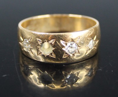 Lot 450 - A 9ct gold diamond set half-hoop ring,...