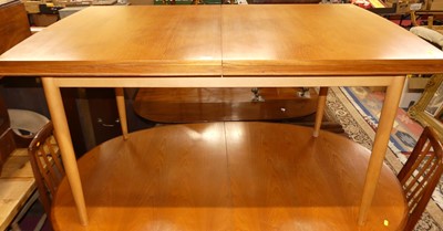 Lot 1295 - A 1970s teak and beech extending dining table,...