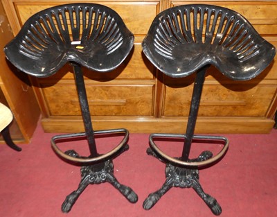 Lot 1342 - A pair of black painted cast iron bar stools,...