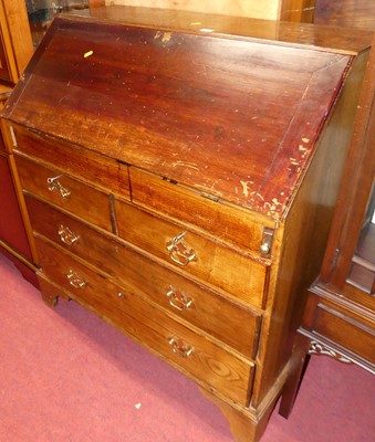 Lot 1379 - An oak slopefront writing bureau, having a...