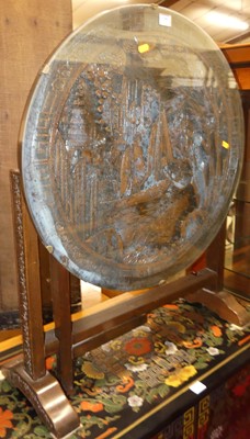 Lot 1381 - An Eastern relief carved teak circular folding...