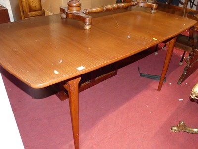 Lot 1396 - A 1970s teak extending dining table, having...