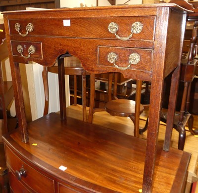 Lot 1412 - A George III oak three drawer lowboy, having...