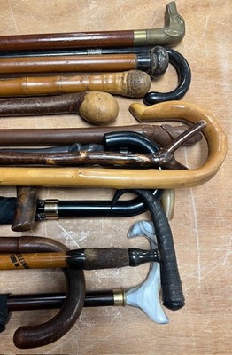 Lot 599 - A collection of walking sticks to include...