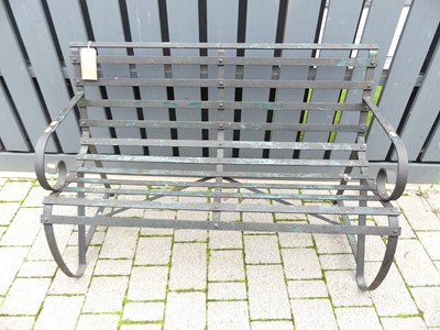 Lot 1423 - A wrought iron strapwork two-seater garden...