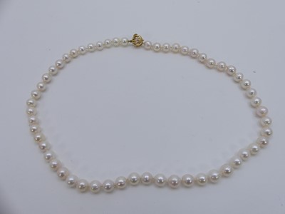 Lot 318 - A Mikimoto cultured and knotted pearl single...