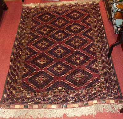 Lot 1177 - A Persian woollen red ground Bokhara rug, the...