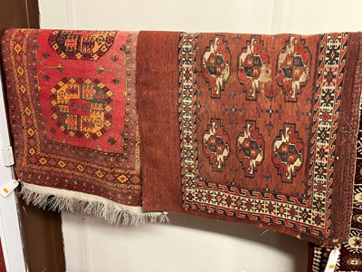 Lot 1182 - A Persian woollen red ground Bokhara rug,...