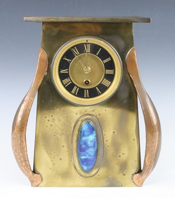 Lot 218 - An Arts & Crafts copper and brass mantel clock,...