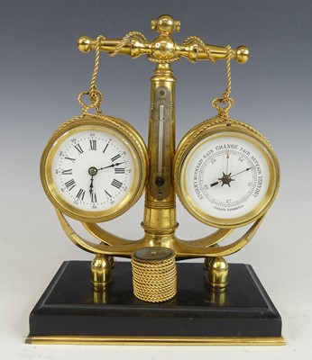 Lot 2520 - A circa 1900 nautical desk brass clock...