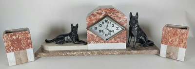 Lot 36 - An Art Deco garniture flanked by dogs