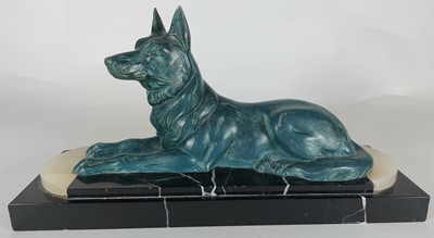 Lot 33 - An Art Deco recumberant dog on marble base