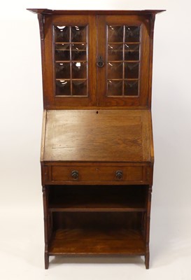 Lot 426 - An Arts & Crafts oak student's bureau bookcase,...