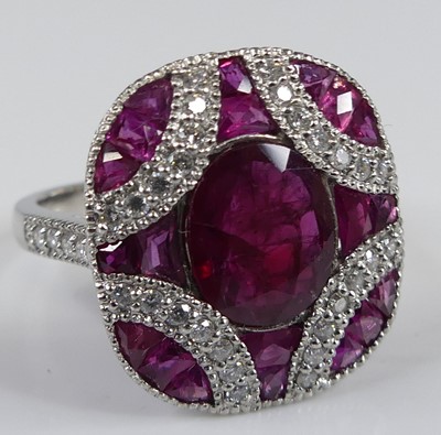 Lot 2255 - A platinum, ruby and diamond oblong cluster...