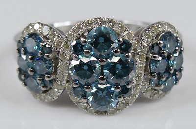 Lot 2230 - A white metal diamond triple cluster ring,...