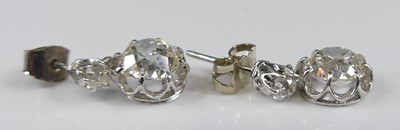 Lot 2276 - A pair of white metal diamond drop earrings,...