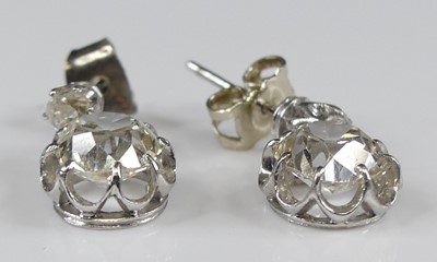 Lot 2276 - A pair of white metal diamond drop earrings,...