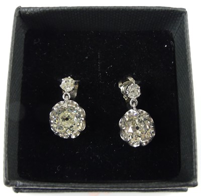 Lot 2276 - A pair of white metal diamond drop earrings,...