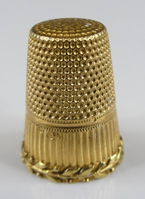 Lot 2410 - A yellow metal engraved thimble, with leaf...