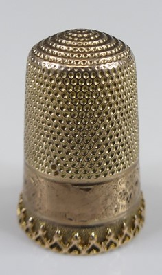 Lot 2408 - An engraved yellow metal thimble, unmarked but...