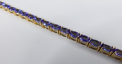 Lot 2226 - A contemporary 18ct gold and tanzanite set...