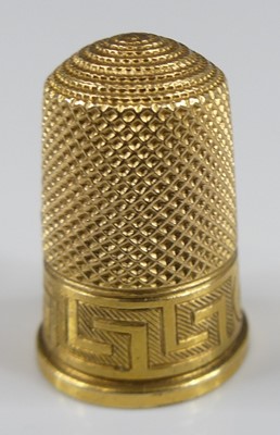 Lot 2409 - A Victorian yellow metal thimble, having a...