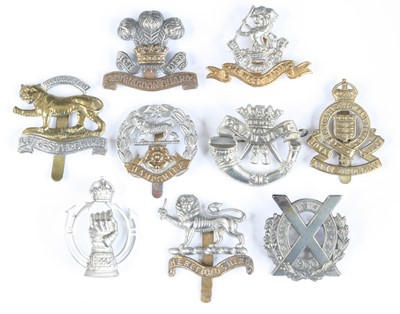 Lot 558 - A collection of assorted cap badges and...