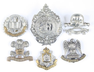 Lot 559 - A collection of assorted cap badges and...