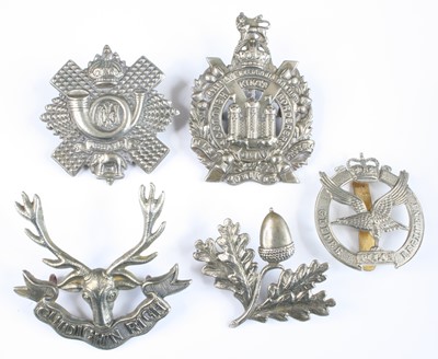 Lot 560 - A collection of cap badges and insignia to...